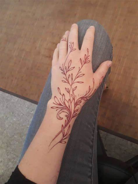 Finger Tattoo with a Minimal Flower and Vine