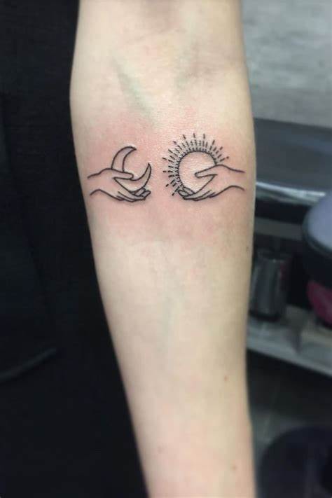 Hand-Holding Sun And Moon Tattoo